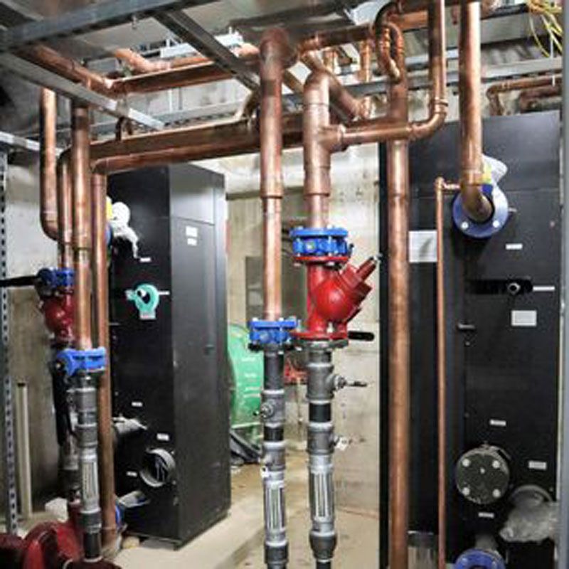 Industrial mechanical room with copper pipes and HVAC components in the DC Metropolitan Area